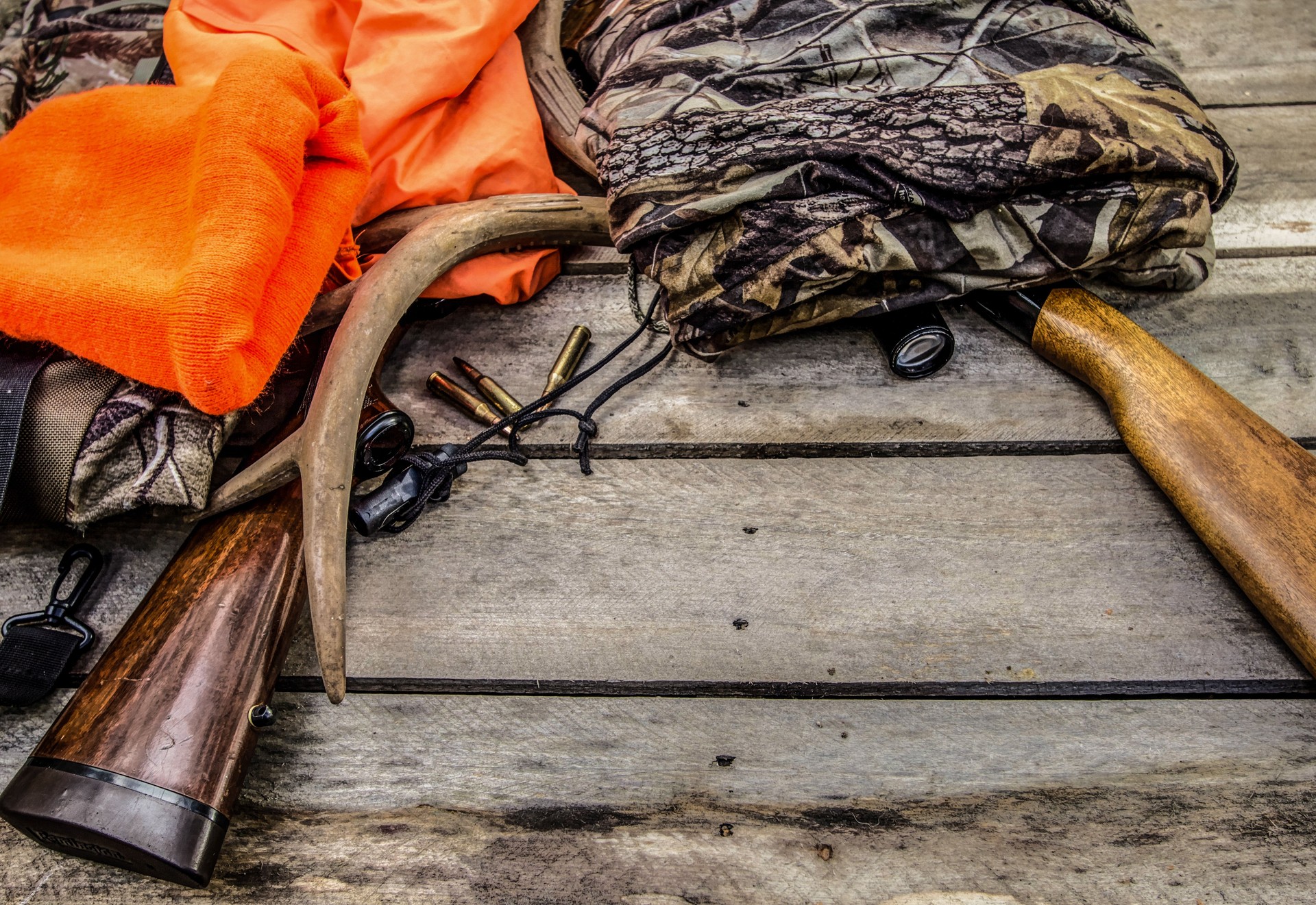 Deer Hunting Gear Background With Rifles, Rattling Antlers, Deer Call And Camouflage